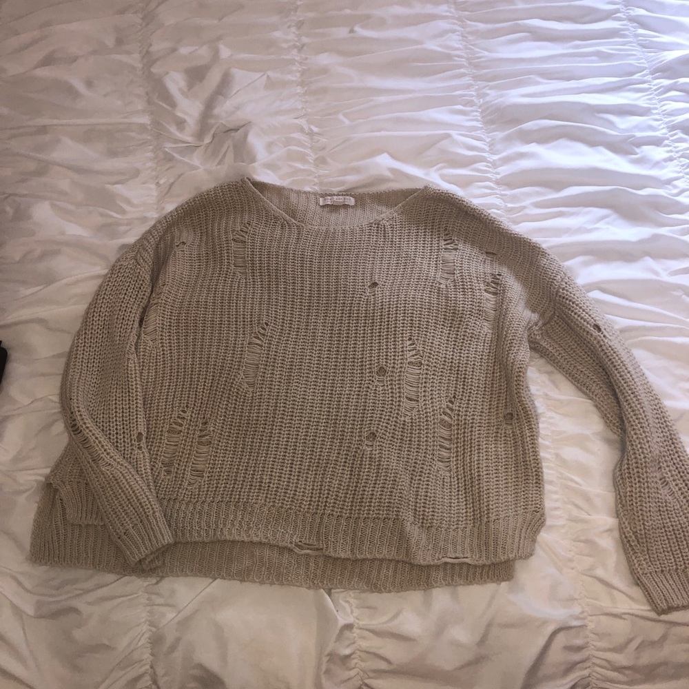 “Ripped sweater”